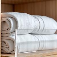 Clear acrylic shelf dividers organizing folded clothes or books